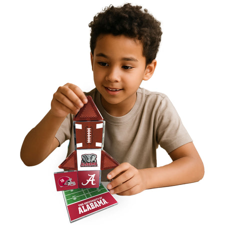 Child playing with a football-themed puzzle, featuring the University of Alabama logo.