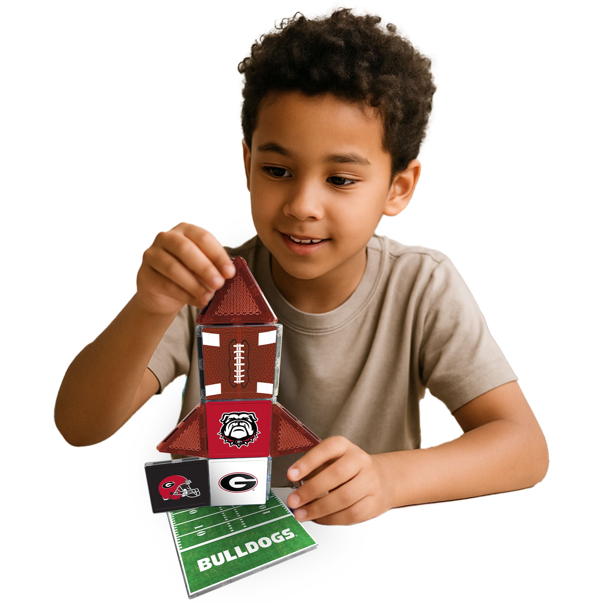 Child playing with a Bulldogs-themed toy set on a white background