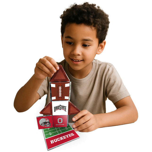 Child holding a Ohio State-themed card with a football design