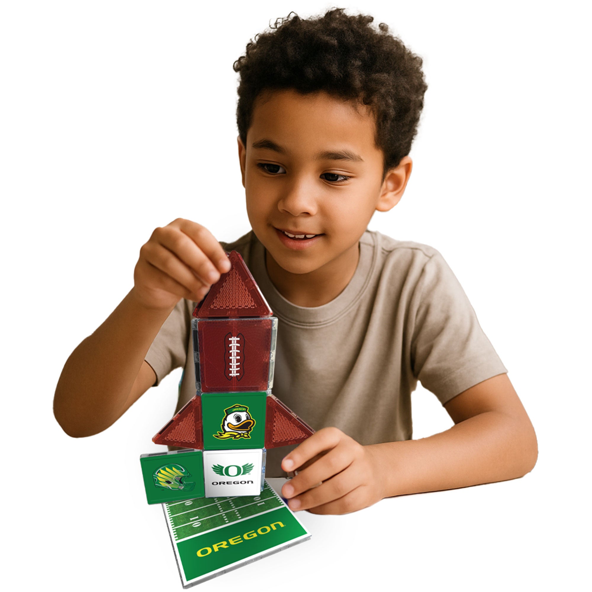 Child playing with a football-themed building set on a white background