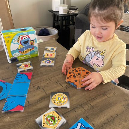 Child playing with colorful card games on a wooden table