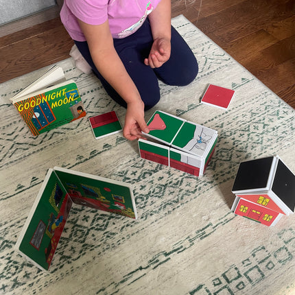Child playing with colorful cards on a patterned rug