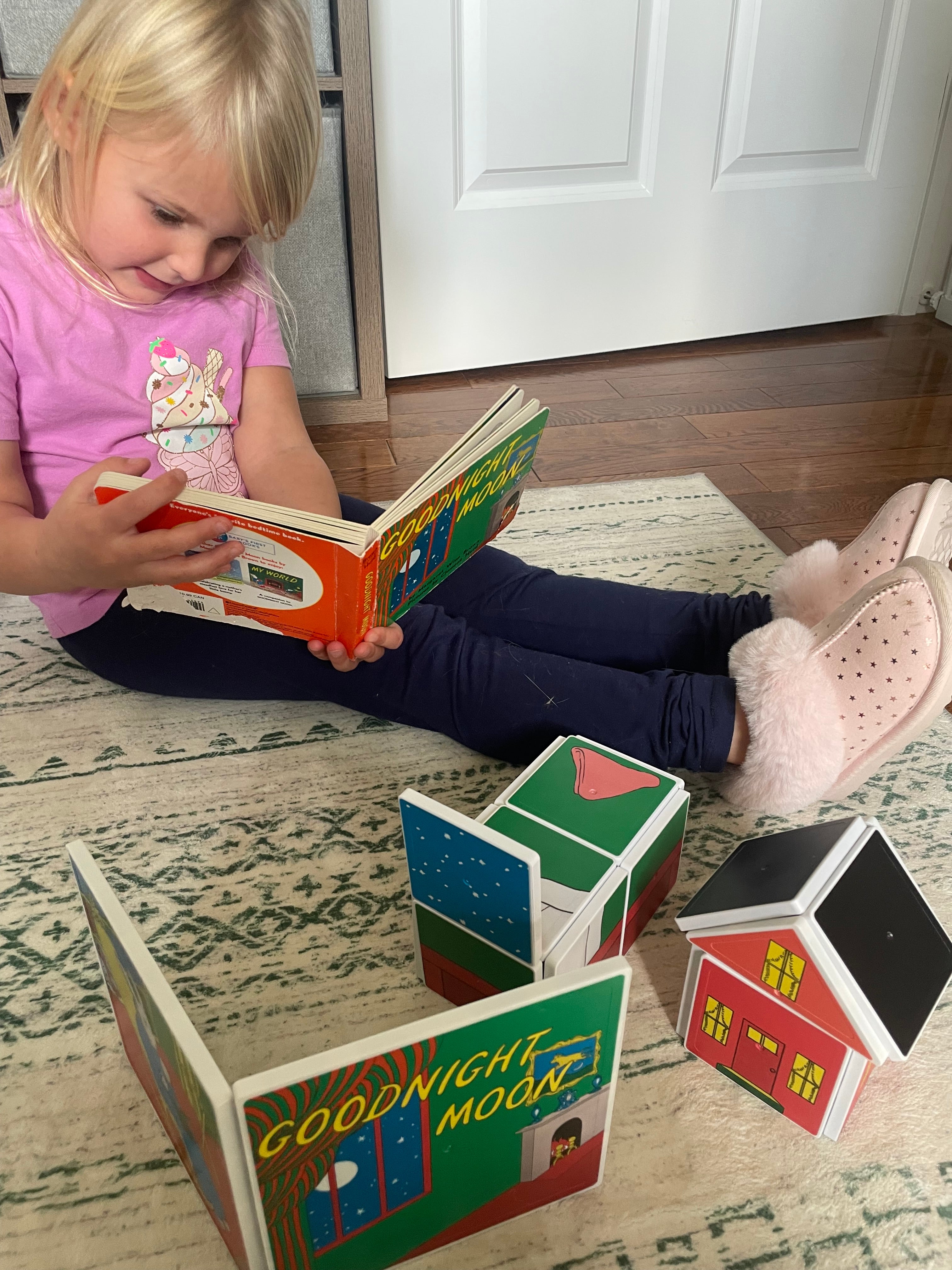 Child playing with colorful blocks on a patterned rug