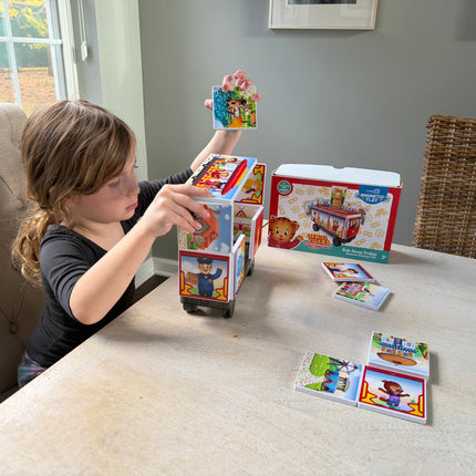 Child playing with magnetic tile set in a home setting
