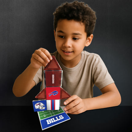 Child playing with a toy set featuring football-themed pieces on a dark background