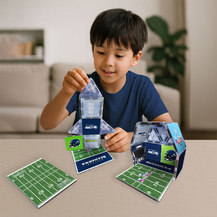 Child playing with a toy football stadium set on a table