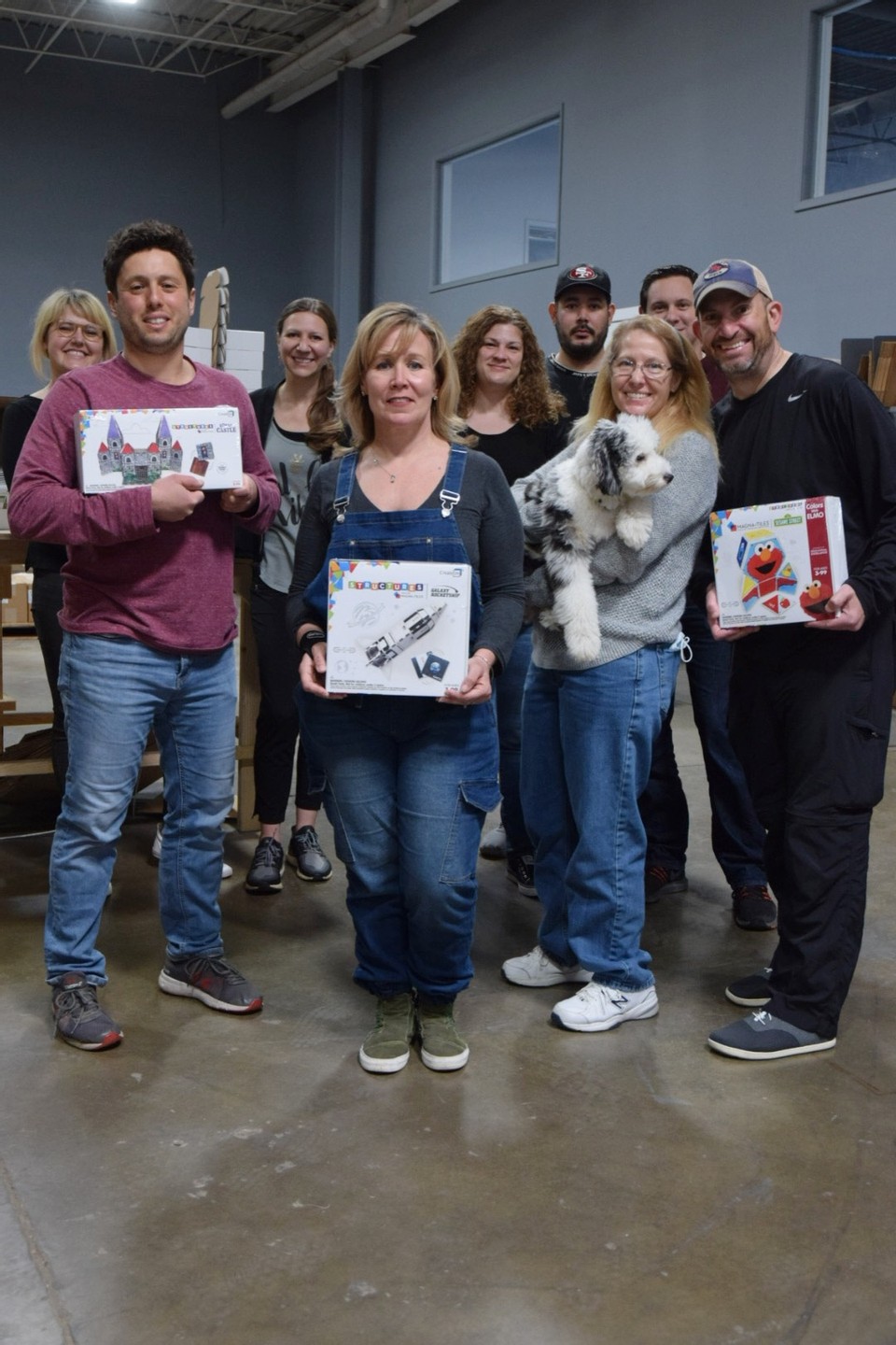 CreateOn team holding stem magnetic tiles