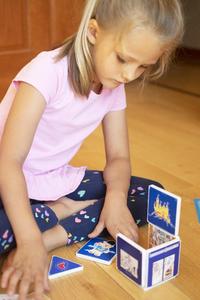 Girl Playing with Magnatiles Set on Livingroom Floor