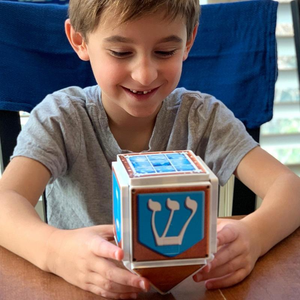 Boy Playing with Hanukkah Ginger Bread House