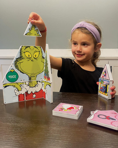 Girl Playing with Grinch Magna Tiles