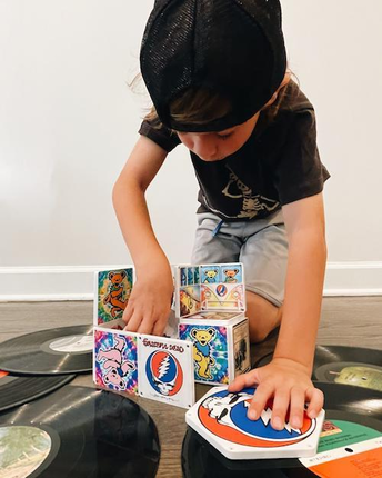 Boy Playing with Grateful Dead Bus Magnatiles with Records on the Floor