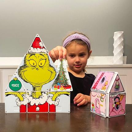 Girl Playing with Grinch Magna Tiles